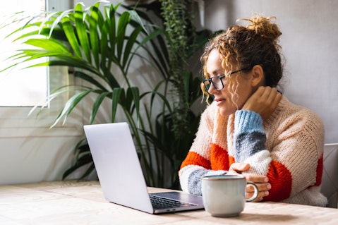 Woman at computer with tea
