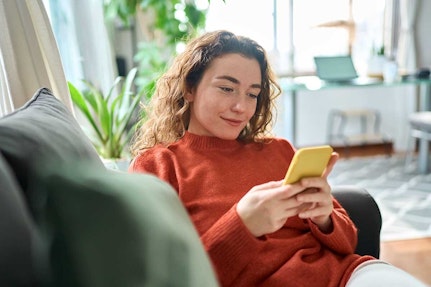 Woman with phone on sofa